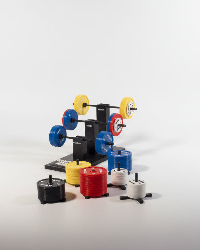 Mini gym rack with colourful weight plates on desk